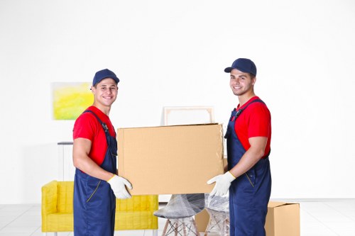 House movers loading furniture on a New Cross street