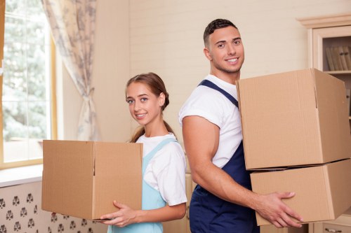 Careful packing and loading of household boxes for a move in New Cross