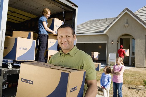 Home moving boxes and furniture prepared for removal van transport