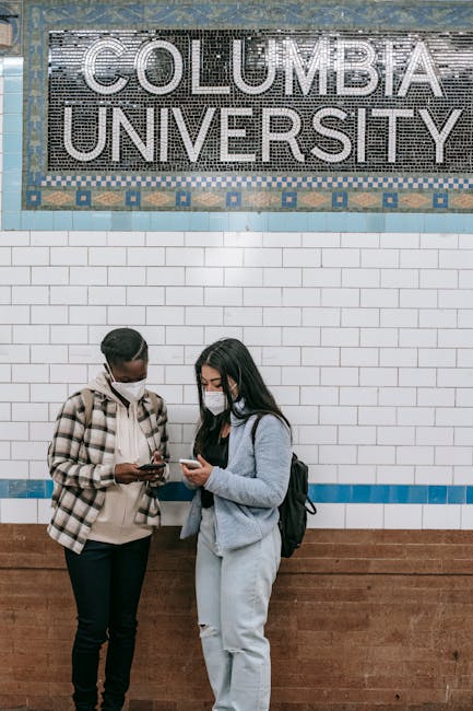 A group of three young people, two women and one man, are walking up a flight of outdoor stairs leading from an underground train station near Columbia University, in an urban area. The women have long dark hair, with one wearing a white cardigan over a white shirt and the other with a beige sweater, both carrying backpacks. The man, with short dark hair, is dressed in a light-colored jacket over a grey shirt and also carrying a backpack. They are smiling and appear engaged in conversation, with daylight illuminating the scene. Behind them is a green metal fence and the station signage indicating '116 Street Columbia University' and the bus number 1, suggesting they are preparing for a home relocation or move-in process. The environment includes visible pavement, a portion of a yellow taxi, and the entrance to the station, aligning with moving logistic activities supported by [COMPANY_NAME], such as packing and transport during a house or student move.